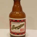 A beer bottle with label that reads, Marathon Superfine Premium Beer"