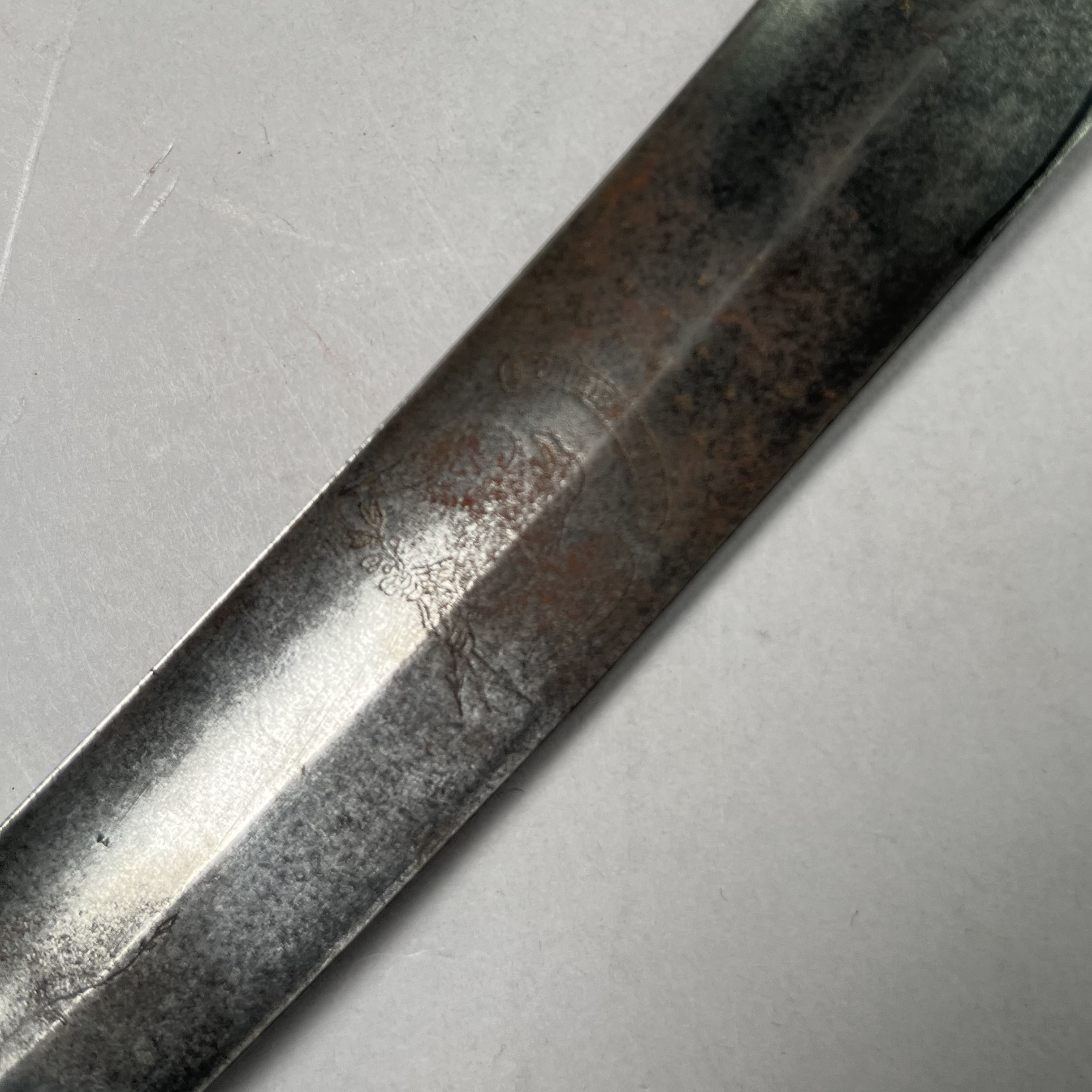 Detail of the sword blade showing an engraving of an eagle.