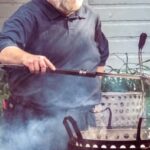 A master boiler holds a two-sided spork--a ladle lashed to the handle end of a long carving fork.