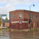 Exterior of Smart Studios, an unassuming brick building on a street corner.