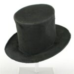 A black beaver-felt top hat on a display stand.