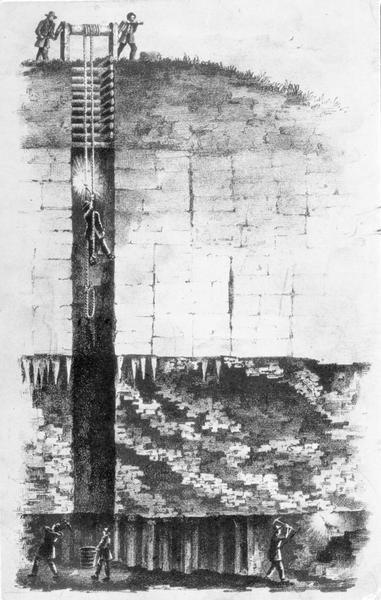 A cross-section drawing of a lead mine. At the top, at the surface, two men operate a windlass to lower a man on a rope into a vertical mine shaft. Below, three men with pick-axes mine for lead.