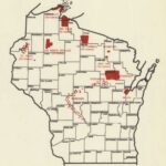 An outline map of Wisconsin with county lines. Reservation lands are marked in red.