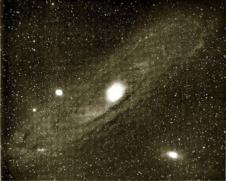 Image of a star nebula, a bright star at the center of a spiral nebula.