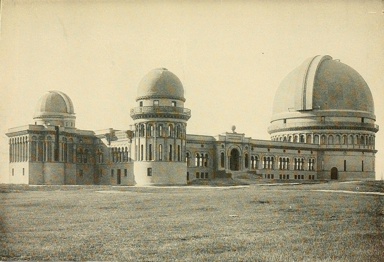 Early photograph of the Yerkes Observatory, a Beaux-arts building with three telescope tower domes and a central hall.
