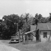 a black and white photo of poorly maintained migrant workers cabins from 1962