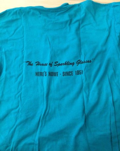 Back of 602 Club T-Shirt, which reads: "'The House of Sparkling Glasses' Here's Howe - Since 1951" 602 Club Collection, University of Wisconsin-Madison Archives.