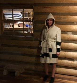 A woman wearing a hooded coat made of a wool trade blanket.