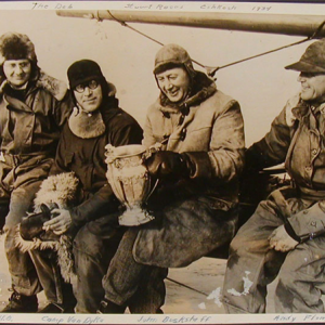 Carl Bernard sitting with three friends at the Stuart Cup race in Oshkosh, 1934
