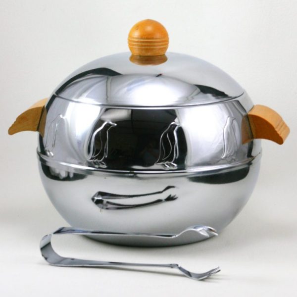 Image of the penguin server, a round aluminum object with wooden handles and repeating molded penguin reliefs around the top.