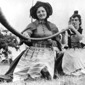 Women in Monroe demonstrate how to use an alpenhorn, a traditional Swiss instrument to call livestock in from the field, 1955. Courtesy of the State Historical Society of Wisconsin, Image ID 43995.