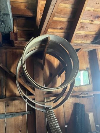 Wooden hoops hung on a post.