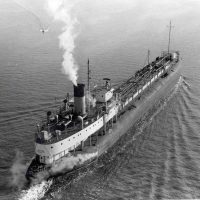 A black and white image of the whaleback ship, the SS Meteor steaming across one of the Great Lakes